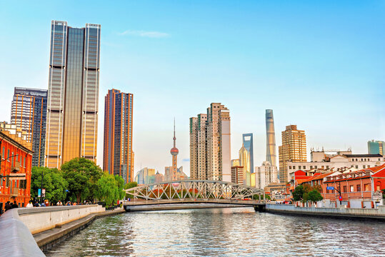 Skyline view of Shanghai during magic hour at Suzhou Creek with buildings reflecting soft light