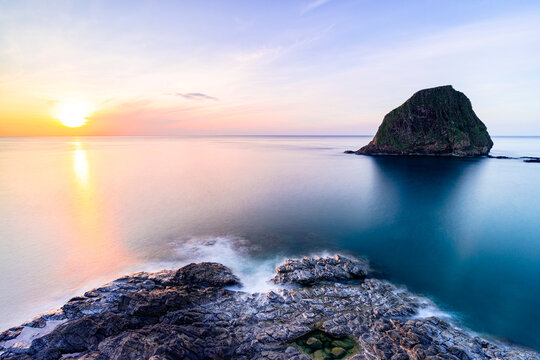 Sunrise over blue sea with rock formation in Tuy An, Phu Yen Province, Vietnam