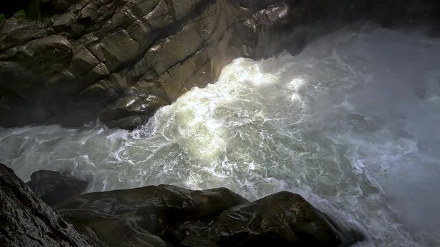Rushing Whitewater Rapids in Dark Rocky Gorge in Ecuador, Powerful River Flow, Canyon Walls and Tropical Nature Adventure Background