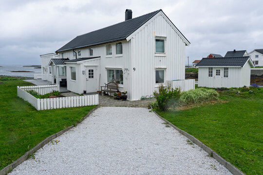 White house with porch and garden near the coast in Veiholmen, Smola Municipality, Norway