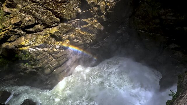 Rainbow Over Powerful Whitewater River in Rocky Ecuador Gorge, Misty Canyon, Sunlight, Dark Stone Walls and Scenic Nature Adventure