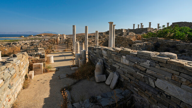 Ruins at the House of Cleopatra located in the Delos archaeological site in Greece feature ancient structures with columns and stone walls
