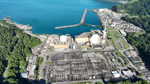 Nuclear energy as an alternative energy source. Operational nuclear power plant. Aerial view. establishing shot.