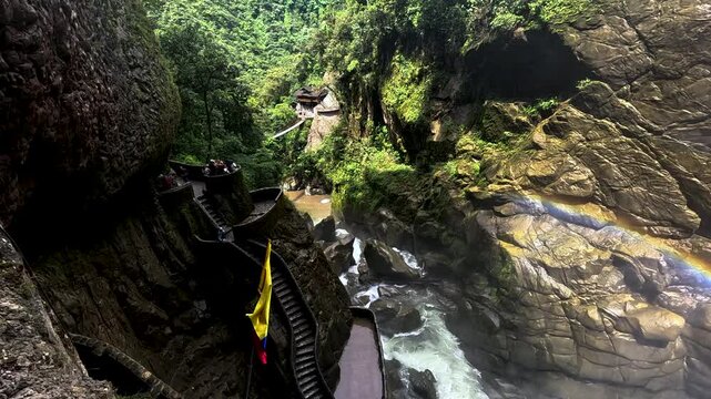 Tourist Stairway Through Narrow Waterfall Gorge in Ecuador, Rocky Canyon Walls, Whitewater River, Rainbow Mist and Adventure Travel Scene