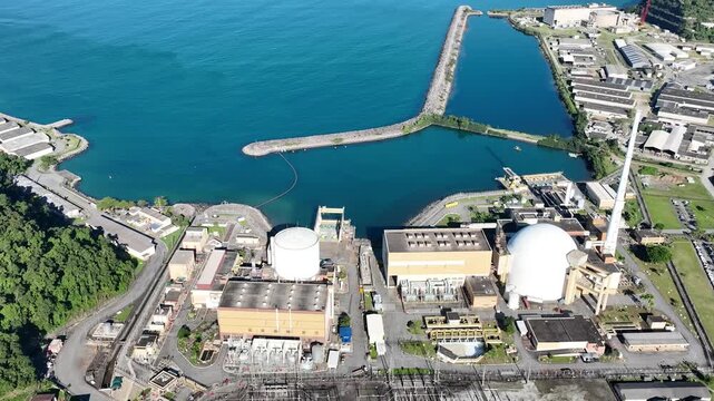 Nuclear energy as an alternative energy source. Operational nuclear power plant. Aerial view. establishing shot.