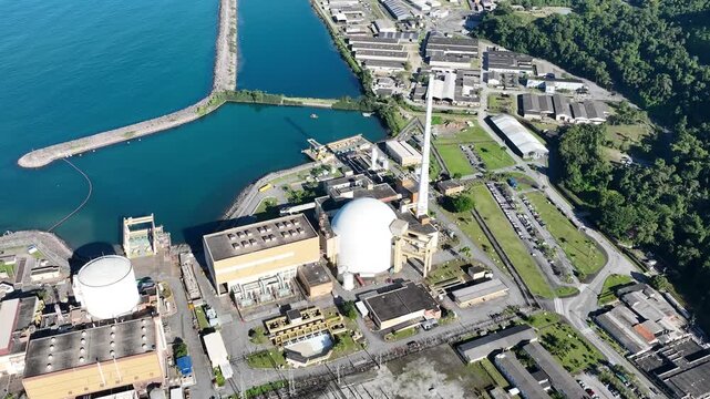 Nuclear energy as an alternative energy source. Operational nuclear power plant. Aerial view. establishing shot.