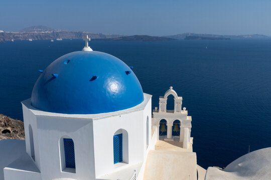 Blue dome of Orthodox Church of Anastasis overlooking the sea on Santorini Island in Greece during a clear day