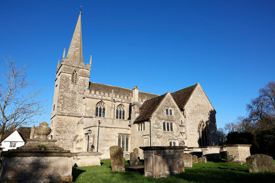 Traditional architecture and historic church in Lacock with clear blue sky above