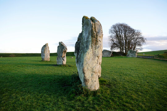 Explore standing stones at Avebury, a Neolithic henge with the largest stone circle in the world surrounded by a village in Wiltshire, United Kingdom