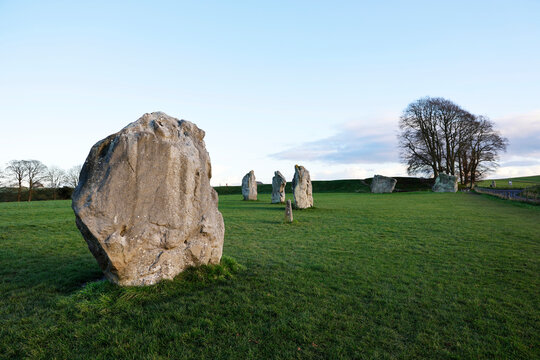 Exploring standing stones at a Neolithic henge monument in the countryside of Wiltshire, England, part of a UNESCO heritage site