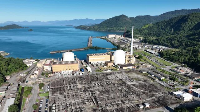 Nuclear energy as an alternative energy source. Operational nuclear power plant. Aerial view. establishing shot.