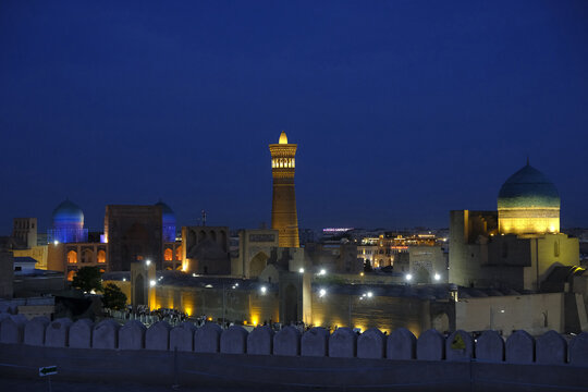 View of historical buildings and landmarks in Bukhara from Ark of Bukhara fortress during nighttime