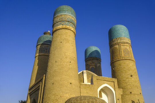 Chor Minor stands tall with blue domes under clear sky in Bukhara, Uzbekistan showcasing unique architecture and heritage elements