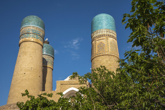 Chor Minor stands tall with its towers under a clear sky in Bukhara Uzbekistan