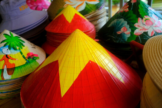 Traditional Vietnamese conical hats displayed at a market in My Tho, Tien Giang, during a vibrant shopping day in Vietnam
