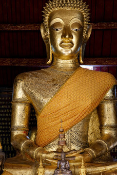 Giant golden Buddha statue performing Dhyana mudra at Wat May Souvannapoumaram in Luang Prabang, Laos
