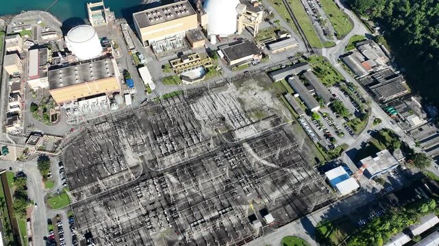 Nuclear energy as an alternative energy source. Operational nuclear power plant. Aerial view. establishing shot.