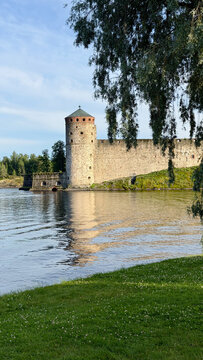 Olavinlinna Castle Tower Framed by Willow Branches in Savonlinna