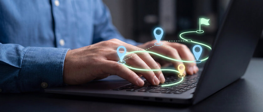 Closeup of a person typing on a laptop with a digital navigation path and location markers overlaid on the keyboard