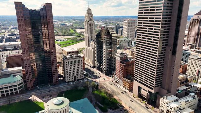 A cinematic drone shot capturing the modern skyline of Columbus, Ohio, USA, showcasing downtown architecture, urban development, office buildings, streets, and the vibrant atmosphere of the state capi
