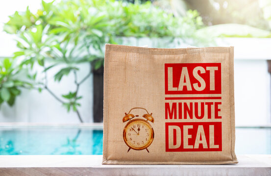 Hessian grocery bag with last minute deal banner on swimming pool edge over blurred green garden background, summer season promotion end