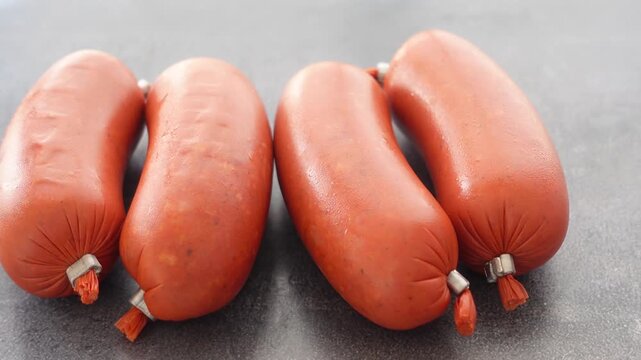 Close up video of four rows of beef sausage. traditional turkish sausage sucuk. spicy fermented sausage in motion