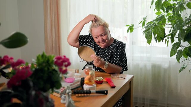 Mature woman observing scalp health and hair loss signs during self exam