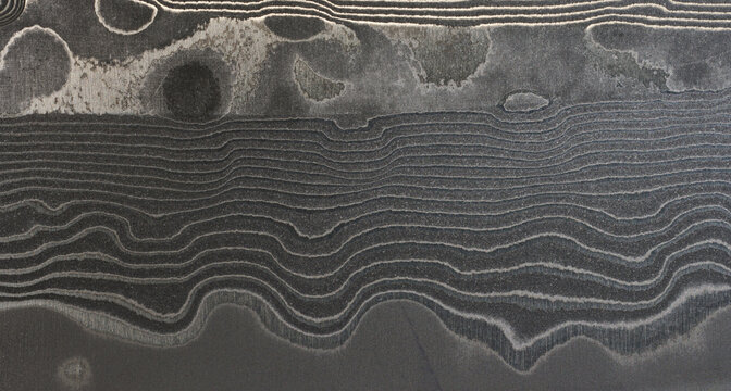 Surface of the Damascus steel blade with a unique wavy pattern