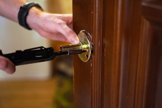 Locksmith Opening Door with Professional Tools