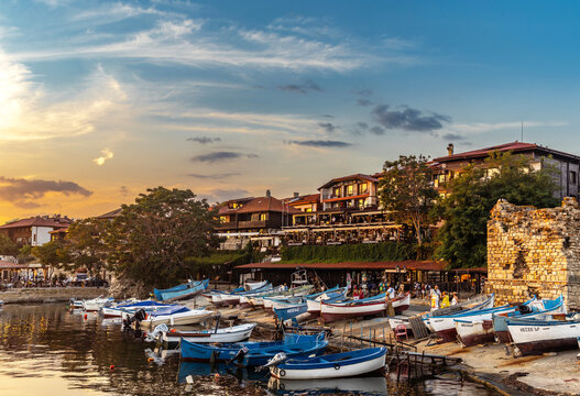 Nessebar, Burgas, Bulgaria - July 15. 2026: Scenic sunset over the old town of Nessebar with fish restaurants and traditional fishing boats, Burgas, Bulgaria