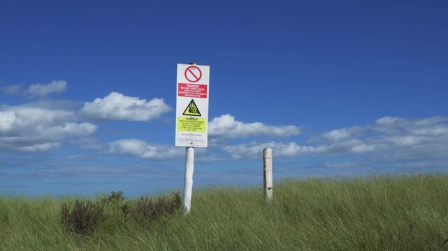 British army base warning signs. Danger of unexploded weapons on a Lincolnshire beach danger of explosions and death. Keep our. Environmental issues and destruction of nature