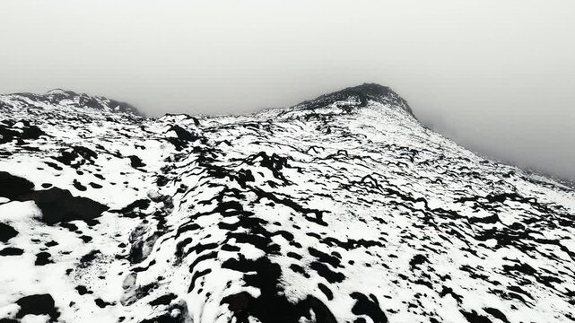 Panoramic Snow Covered Volcanic Landscape in Ecuador Andes, Foggy Mountain Ridge, Black Rocks, High Altitude Terrain and Remote Paramo Wilderness