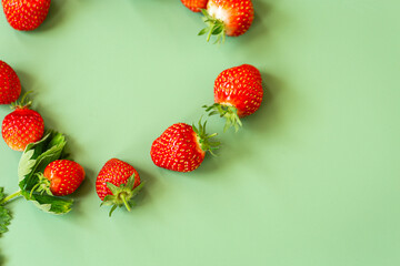 Healthy strawberry harvest on soft green background © Peredniankina