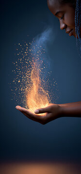Hand fanning glowing flame of divine gift. Hand holding and nurturing a luminous, sparkling energy