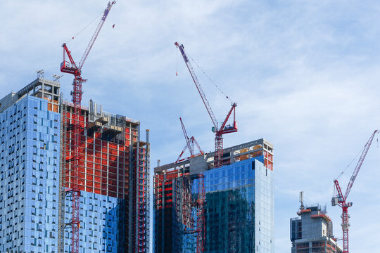 Construction Cranes Over High Rise Buildings