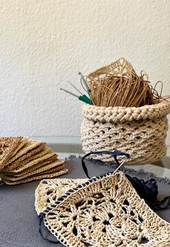 crochet granny square's with hook and handmaid storage basket 