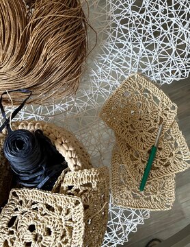 fiat lay crochet project wich raffia ribbon and crochet hook