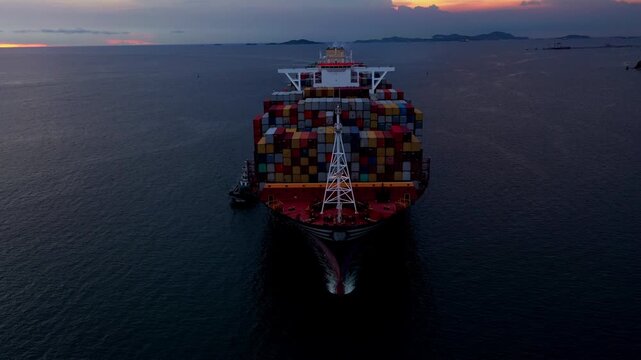 Massive container ship navigating through dark ocean waters at sunset, transporting valuable cargo via distant Port amidst an ominous seascape and maritime trade routes.