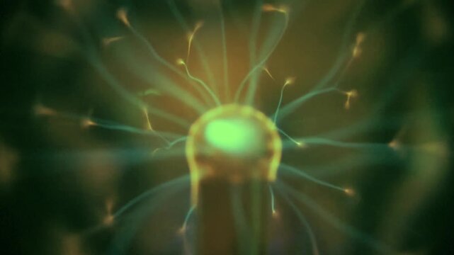 Green and yellow plasma ball lamp generating glowing electric energy discharge filaments. Closeup macro animation of high voltage electrostatic lightning spheres flashing in a dark environment.