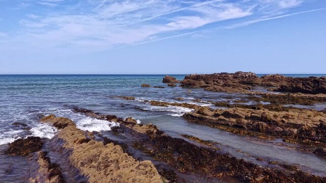 Drone low fly over Cornish rocky beach Sandymouth