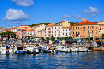 Obraz premium Yachts and sailboats moored in Cala Mangiavolpe in La Maddalena, capital city of the eponym archipelago located in the Mediterranean Sea in Sardinia, Italy