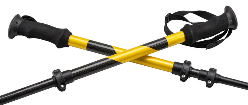 Hiking poles trekking sticks carbon fiber yellow and black crossed outdoor sport equipment isolated on white background for adventure backpacking climbing walking Nordic style trail running gear.