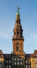 Obraz premium A tall, ornate tower with a green spire on top of a brick building