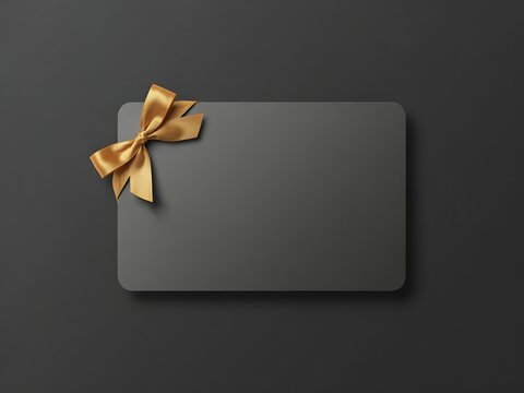 Blank gift card mockup with golden ribbon for branding and promotion, dark background