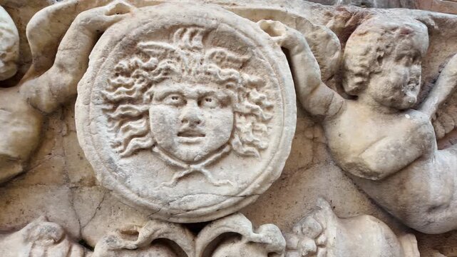 Ancient bas-relief depicting Medusa Gorgon on a classical building in Rome