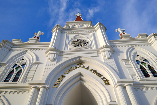 Strong architectural elements of An Hoi Catholic Church in Can Tho built with classic designs and religious symbols under blue sky