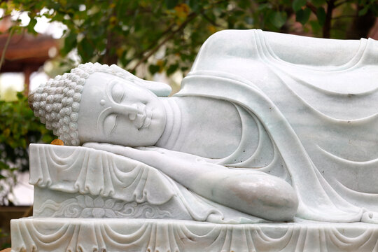 Reclining Buddha sculpture at Truc Lam Phoung Nam Zen monastery represents Buddha's final meditation and passing away in Can Tho, Vietnam