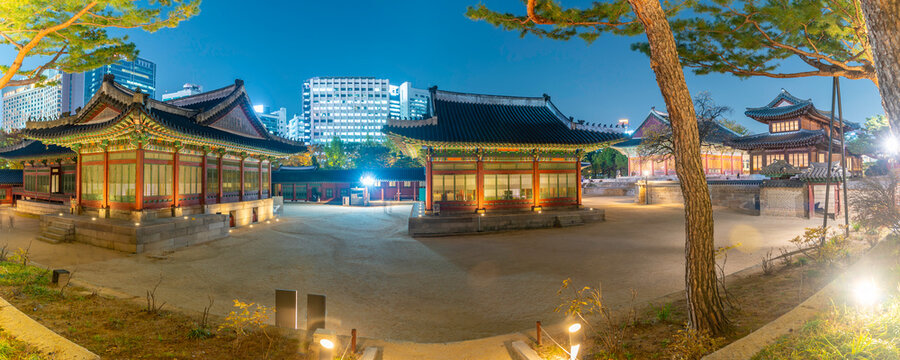 View of Deoksugung Palace with city skyline at dusk during autumn in Jung District Seoul South Korea