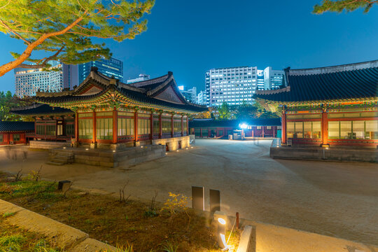 Dusk view of Deoksugung Palace with city skyline during autumn in Seoul, South Korea