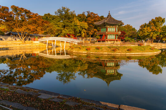 View of Hyangwonjeong Pavilion at Gyeongbokgung Palace during golden hour with autumn colors in Seoul, South Korea